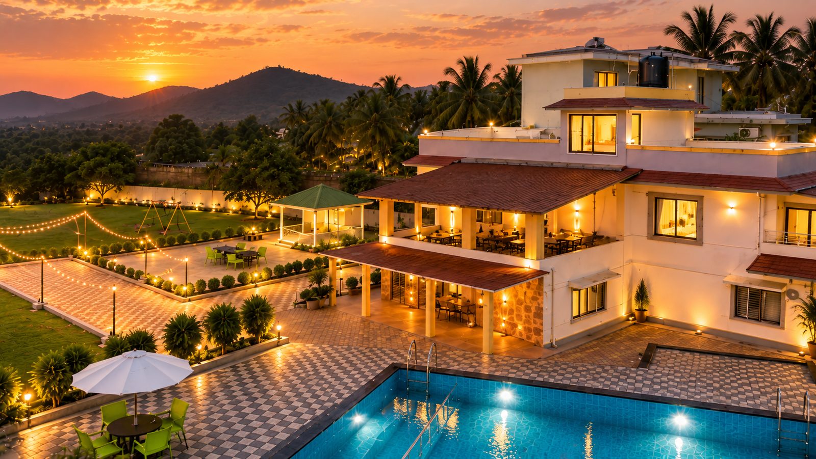 The Morning Glory villa, pool and lawns lit up at sunset